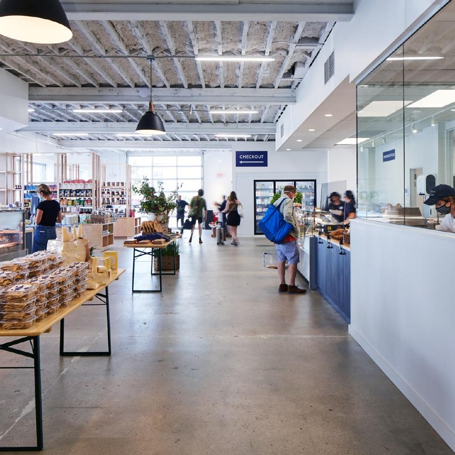 Another view of the store with customers and goods on display.